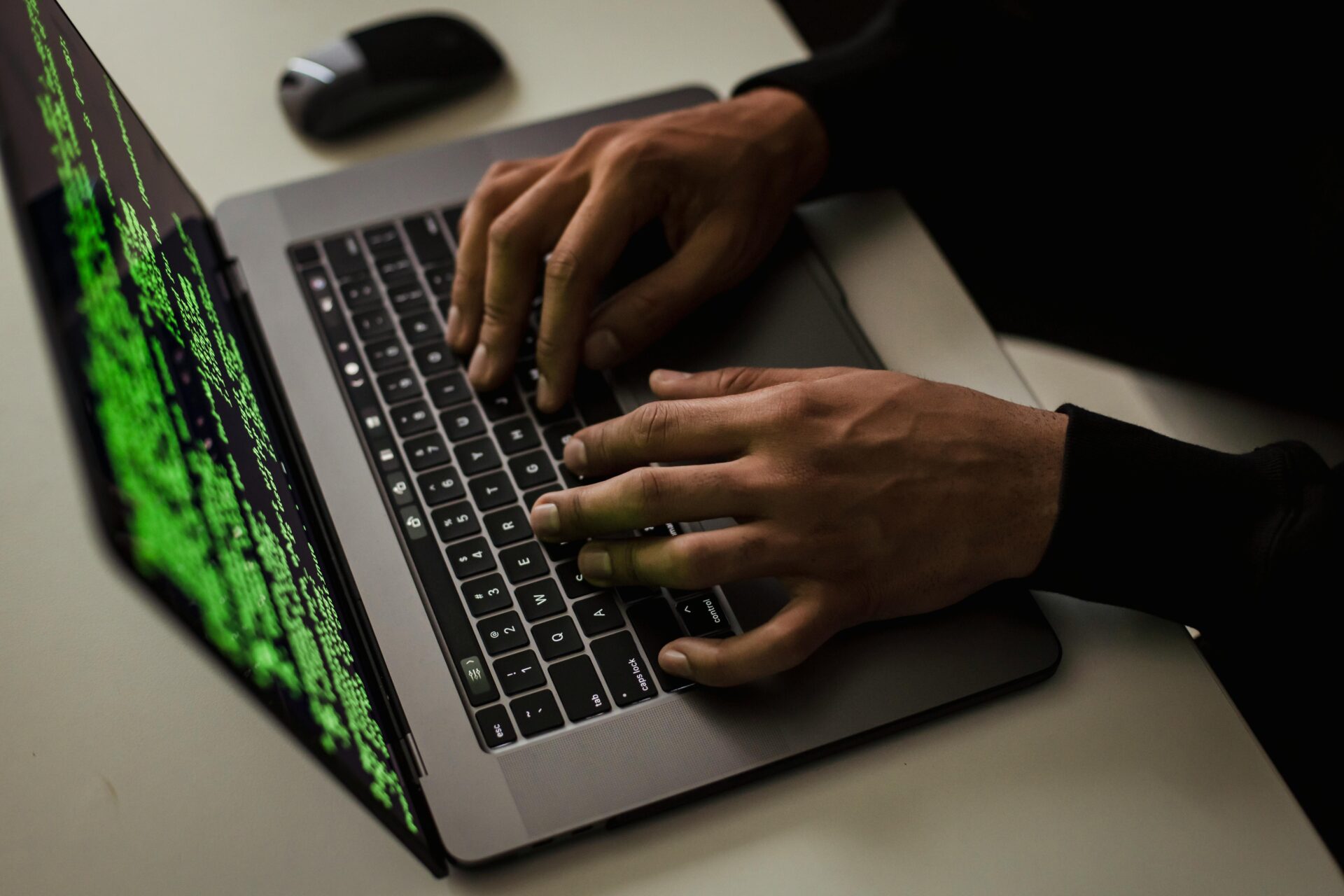 Man typing codes in laptop.